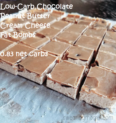 Cream cheese squares on a chocolate layer, topped with a layer of peanut butter